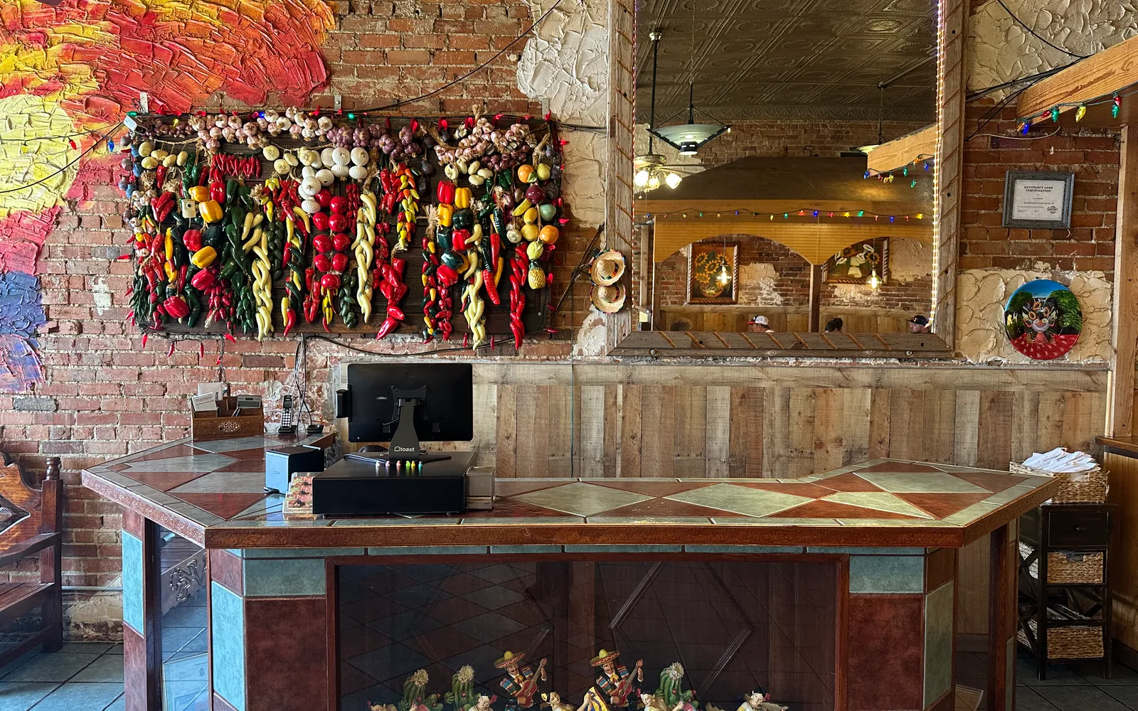 Rustic cashier station at Los Mariachis with hand-carved wood and traditional Mexican details.